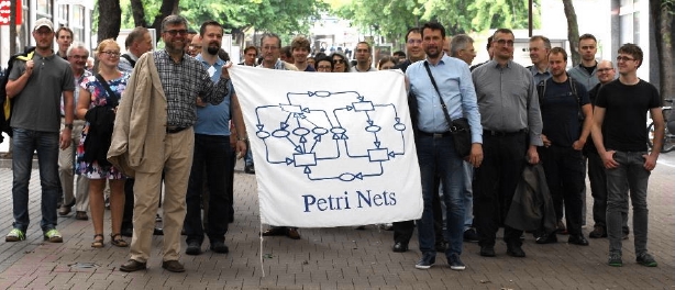 Attendees of Petri Nets 2018 (Bratislava) on the way to the conference banquet. Maciej is on the left, holding the conference banner